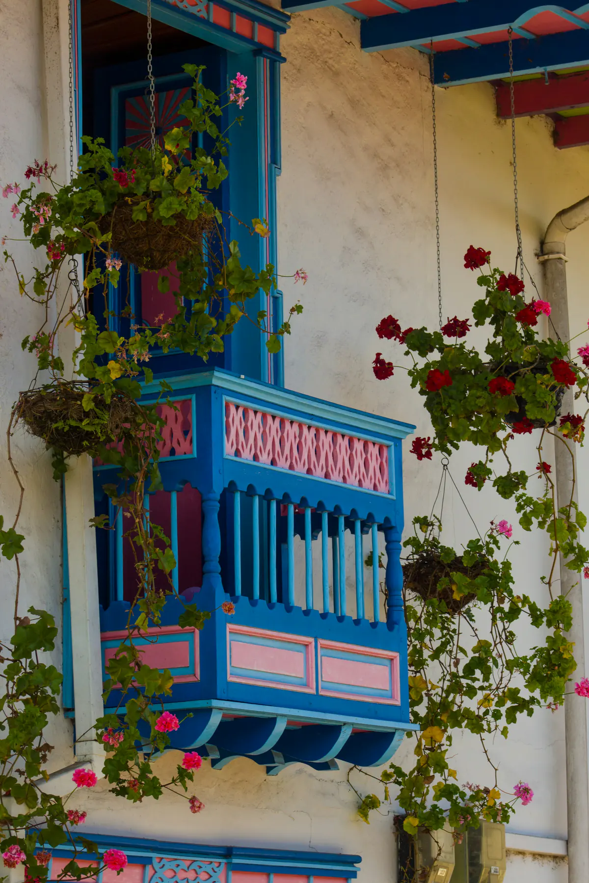 Balcón colorido entre flores, inspirado en la arquitectura de los pueblos cafeteros.